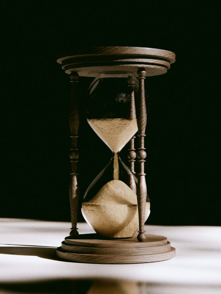Antique hourglass with sand flowing – breaking unhealthy habits one day at a time