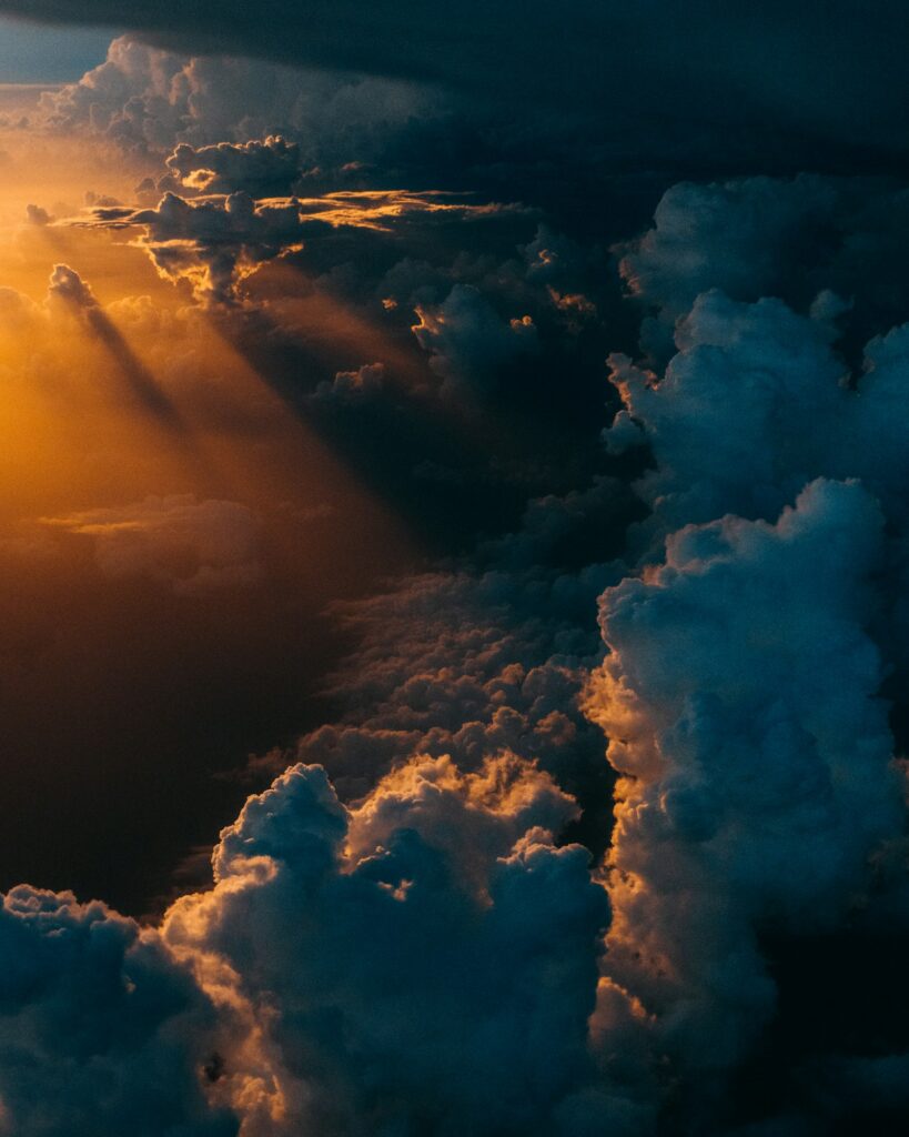 Golden light breaking through clouds – emotional healing after trauma