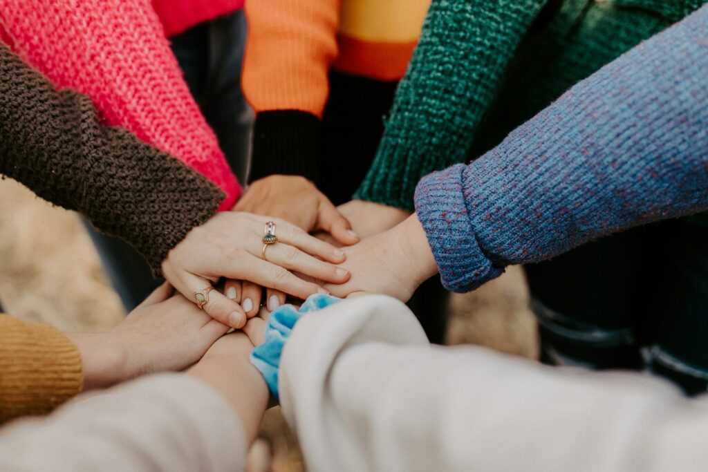 Group stacking hands together – recovery support and community