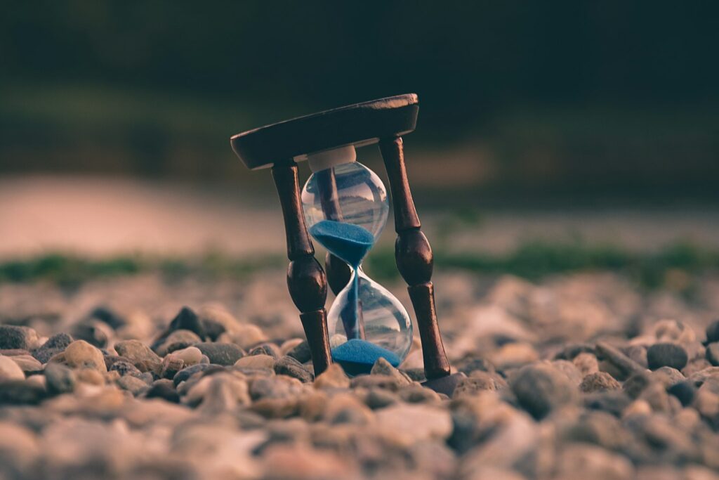 Hourglass resting on stones – reclaiming time from compulsive behaviors