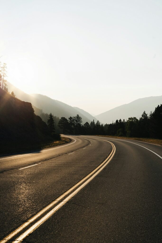 Empty curved road through open land – choosing a new direction in recovery