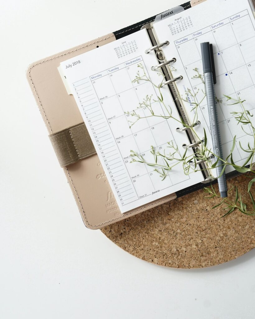Pen on a planner calendar – planning daily recovery routines